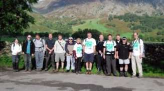 Concept staff in front a big hill on their Macmillan sponsor